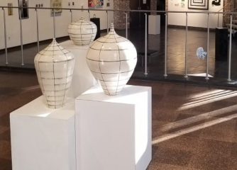 white pottery on display stands