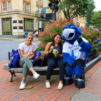 students pose with mascot