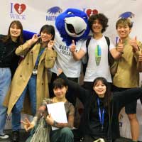 students pose with mascot