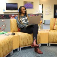 student sitting in commons