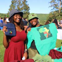 students pose holding sweatshirt